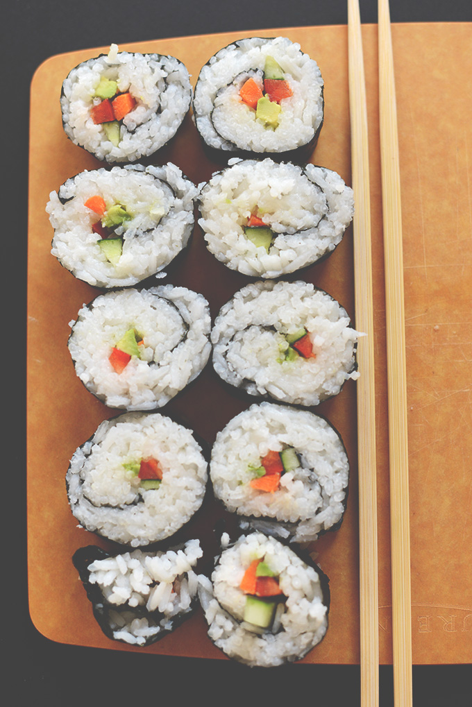 Cutting board filled with homemade Vegan Sushi made without a mat