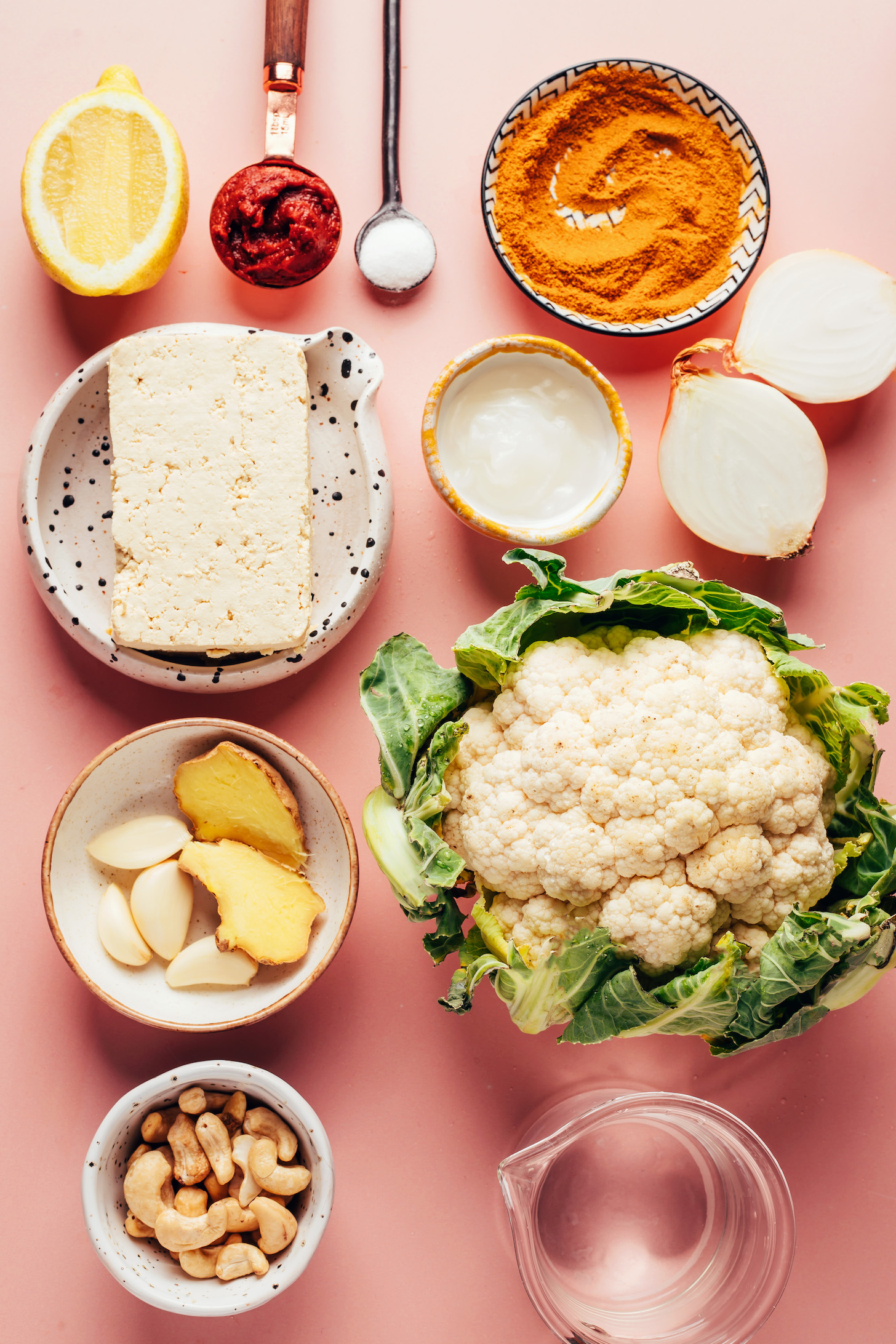 Lemon, tomato paste, curry powder, onion, oil, cauliflower, water, cashews, ginger, garlic, and tofu