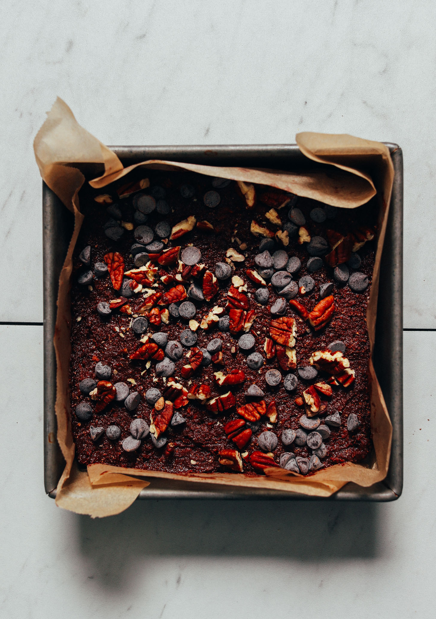 Parchment-lined baking pan filled with a batch of Fudgy Gluten-Free Sweet Potato Brownies