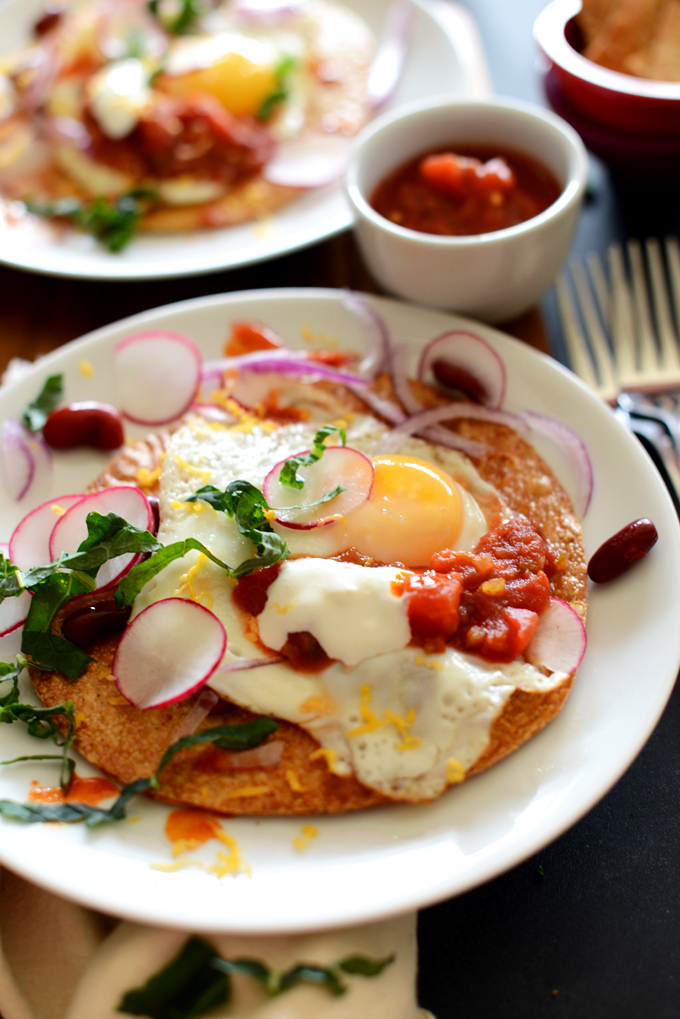 Plate of Gluten-Free Breakfast Tostada made with egg, radish, kale, and salsa