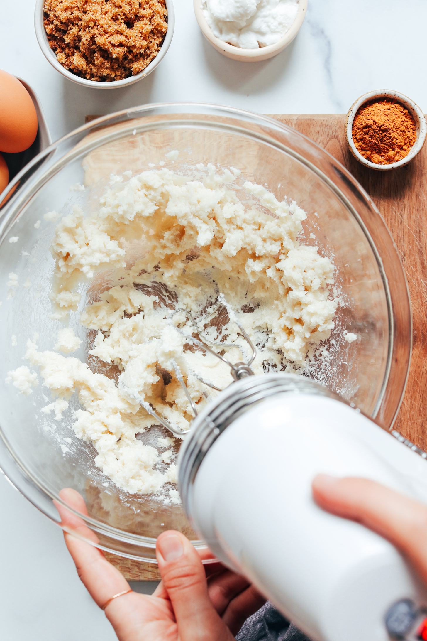 Whipping cane sugar and vegan butter in a mixing bowl