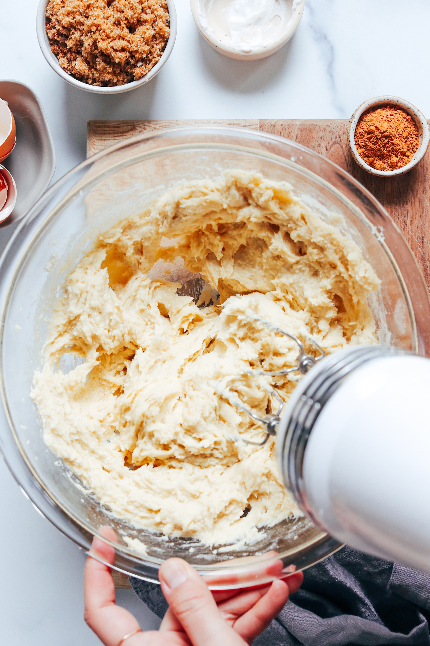 Whipping coffee cake batter in a glass bowl