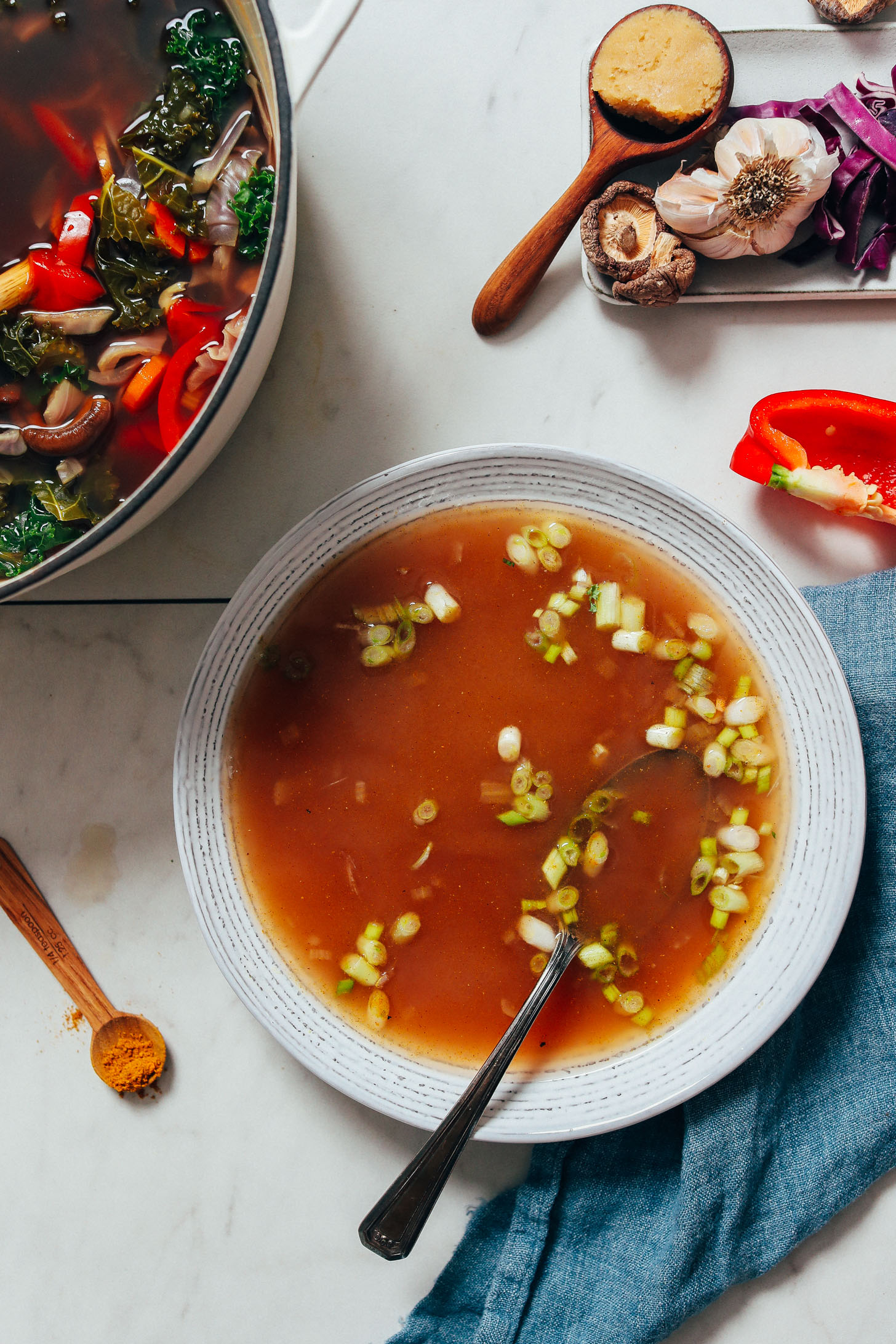 Green onions in a bowl of homemade vegetable broth