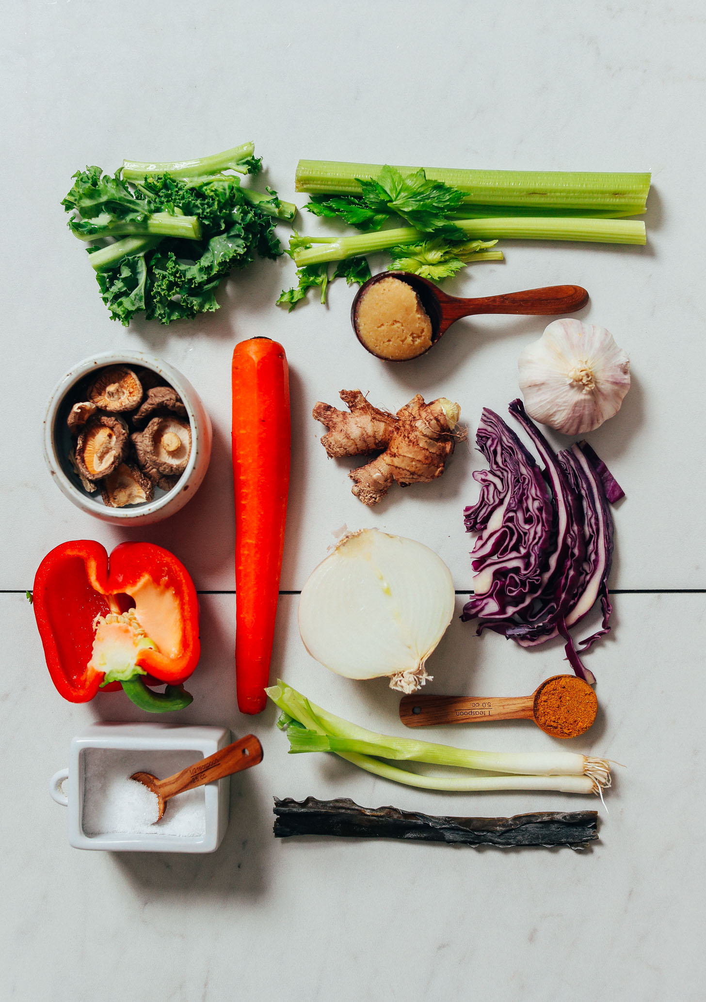 Celery, kale stems, shiitake mushrooms, bell pepper, carrot, ginger, miso, garlic, onion, red cabbage, green onion, kombu, salt, and curry powder