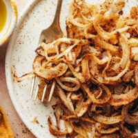 Fork on a plate of homemade gluten-free fried onions