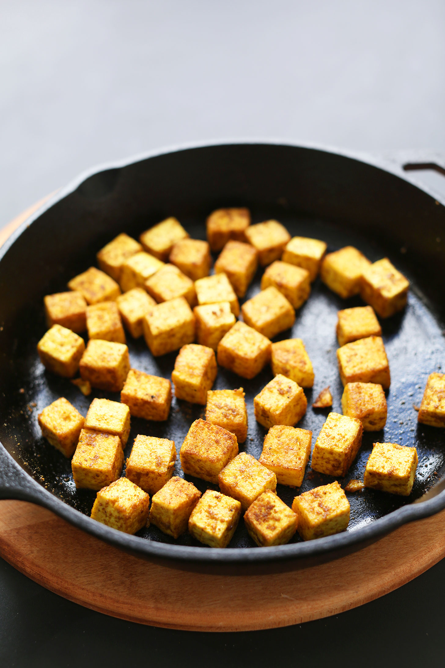 Cast iron skillet filled with cubes of the best Crispy Tofu recipe