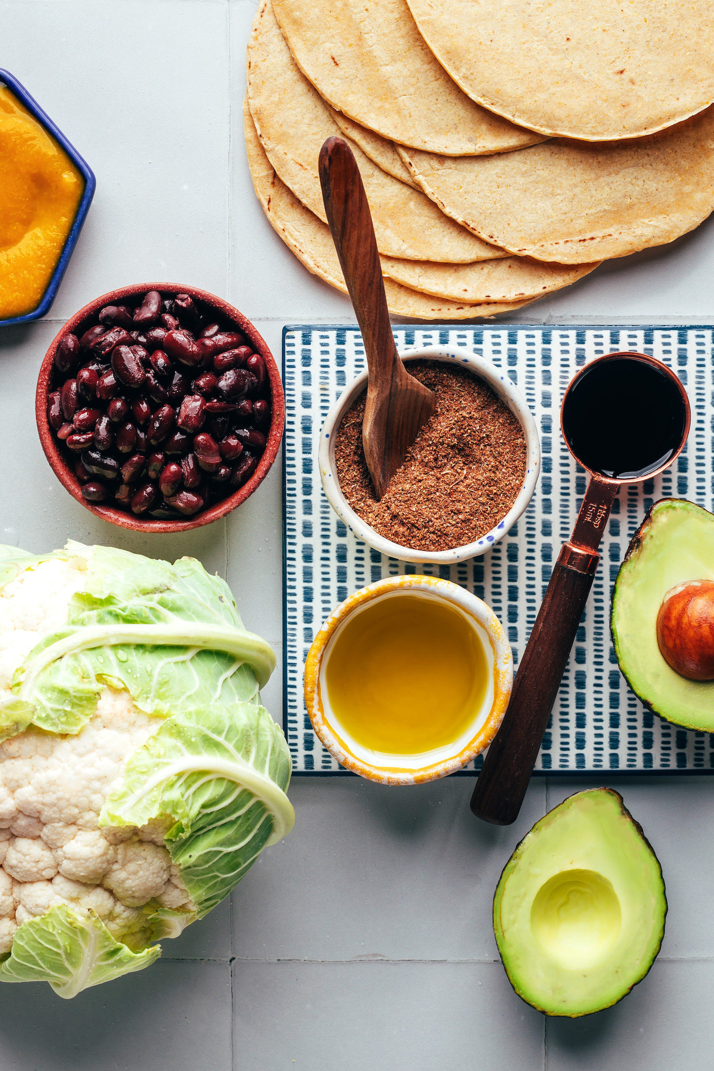 Corn tortillas, avocado, coconut aminos, jerk seasoning, black beans, mango hot sauce, cauliflower, and olive oil