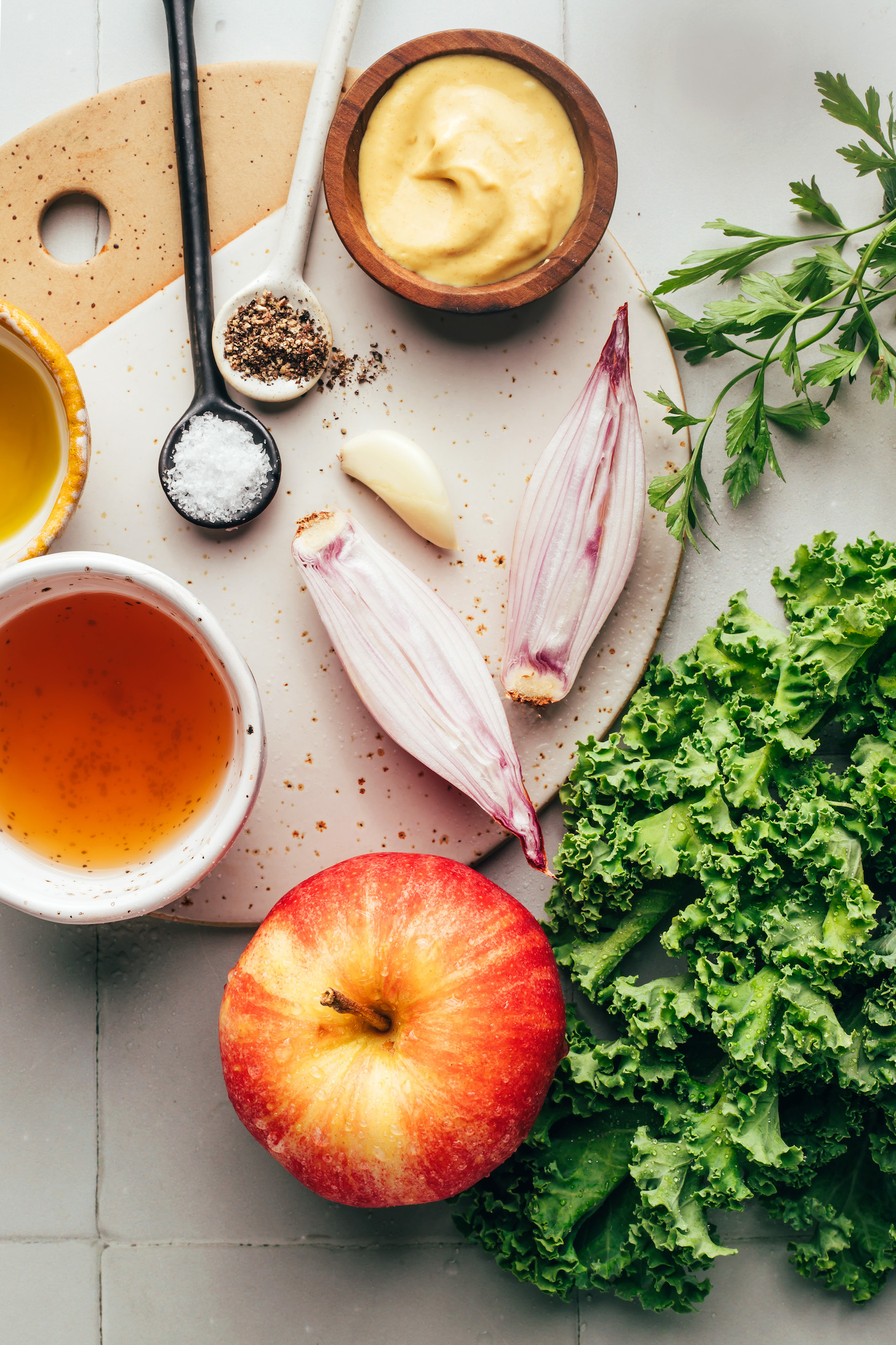 Fresh kale, apple, shallot, parsley, mustard, garlic, salt, pepper, apple cider vinegar, and olive oil