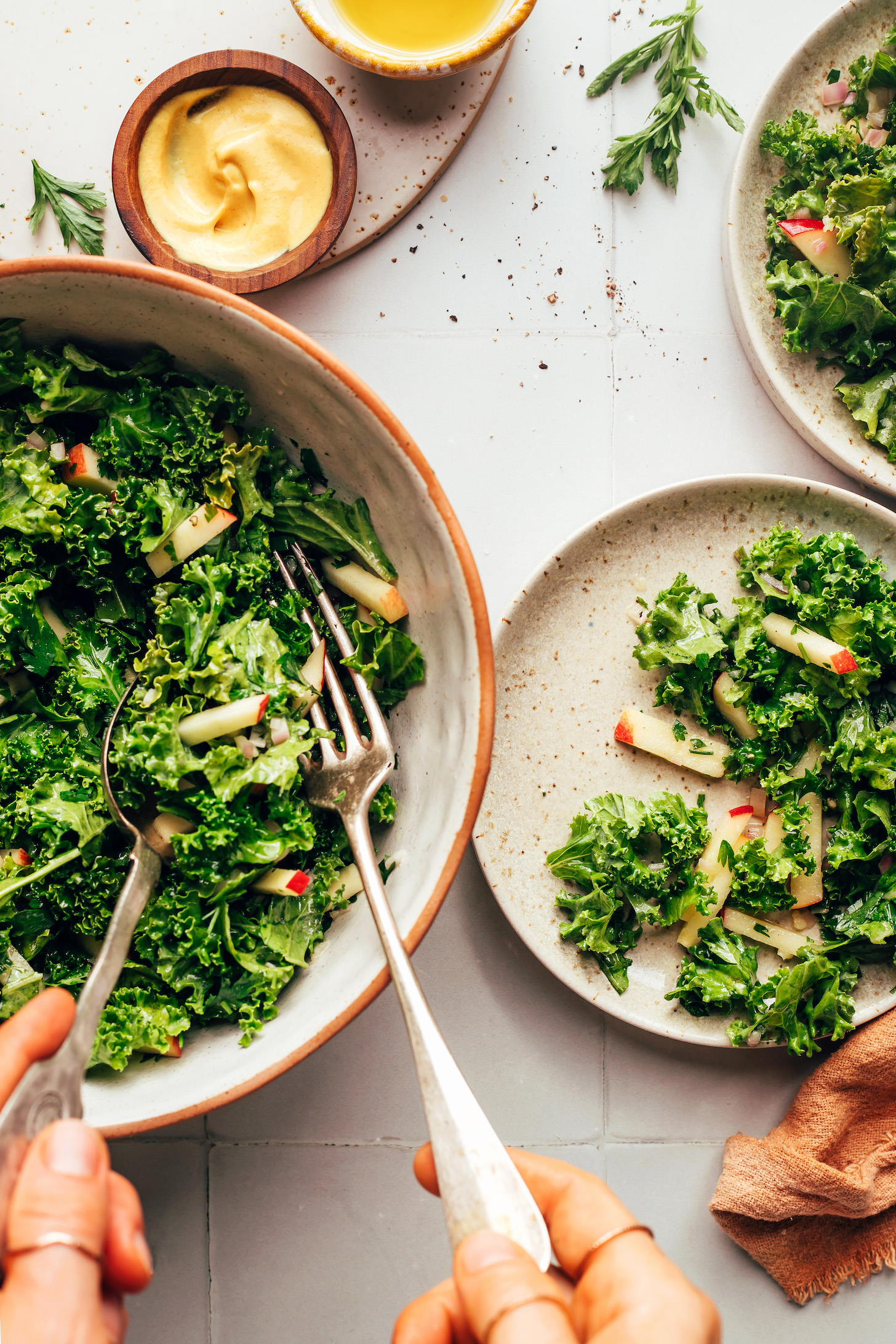 Serving bowl and small plates with kale apple slaw