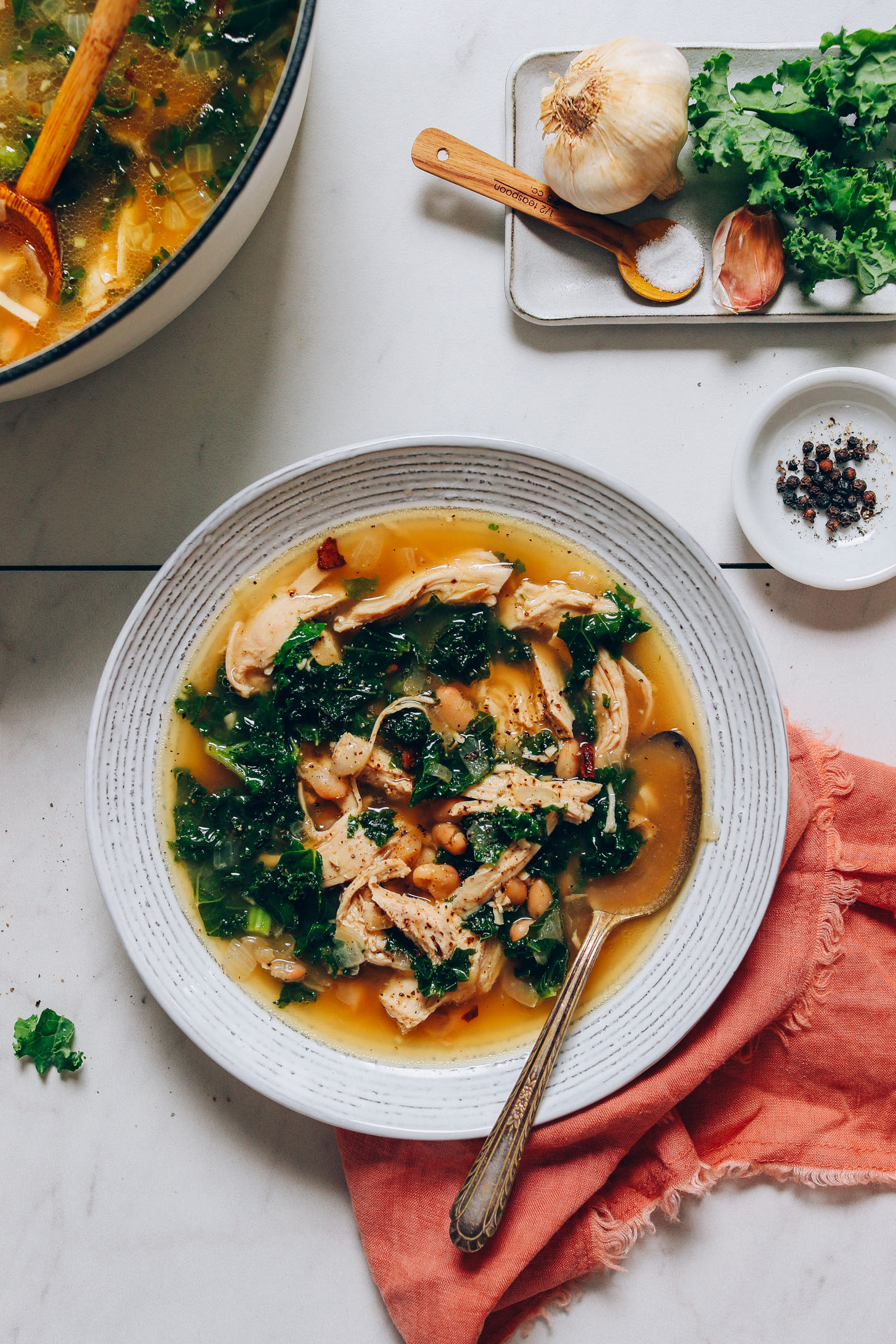 Bowl of grain-free Chicken Soup made with kale and white beans