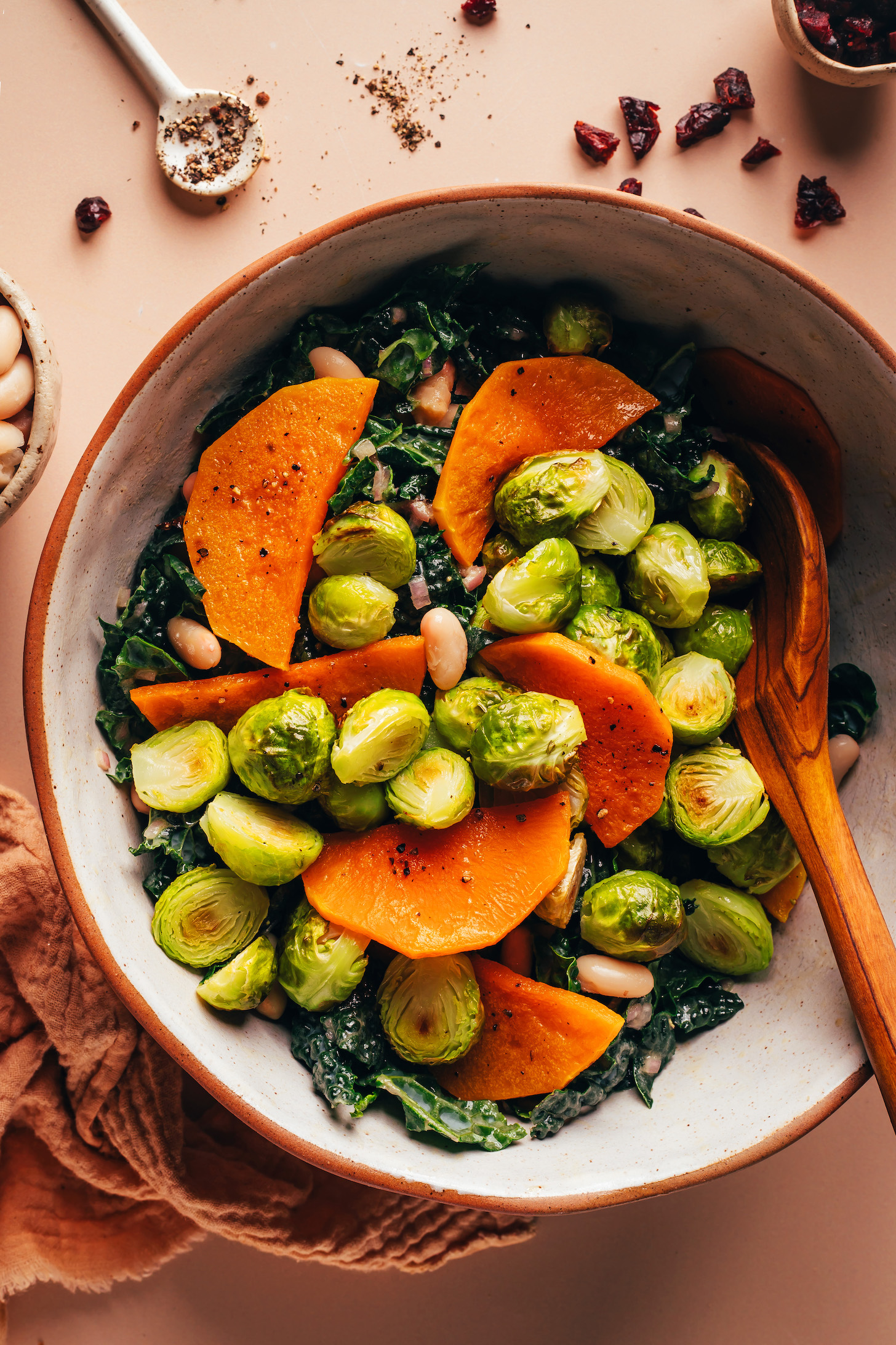 Roasted butternut squash and Brussels sprouts in a bowl with kale and white beans