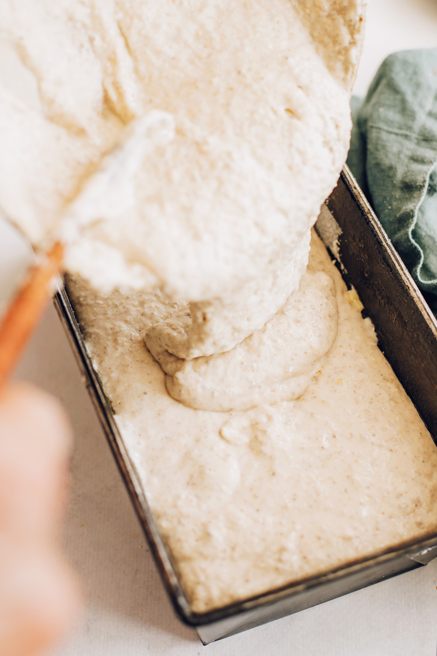 Pouring batter into a loaf pan