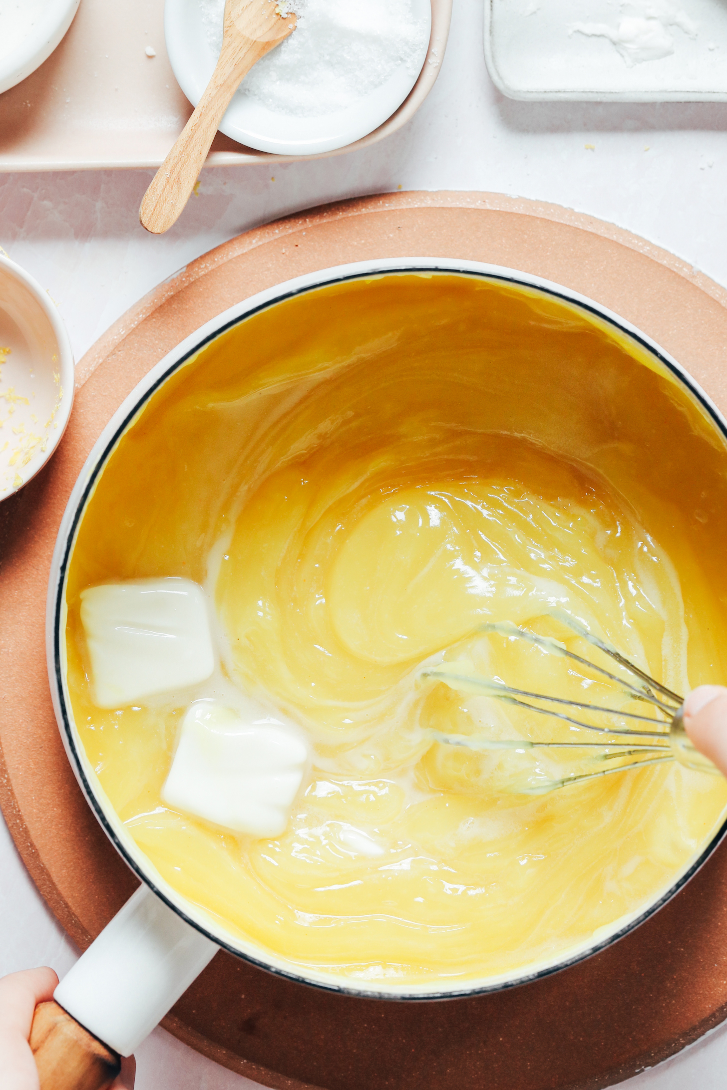 Whisking vegan butter into the vegan lemon curd