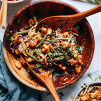 Large bowl and serving bowls of our tofu noodle stir fry recipe made on a sheet pan