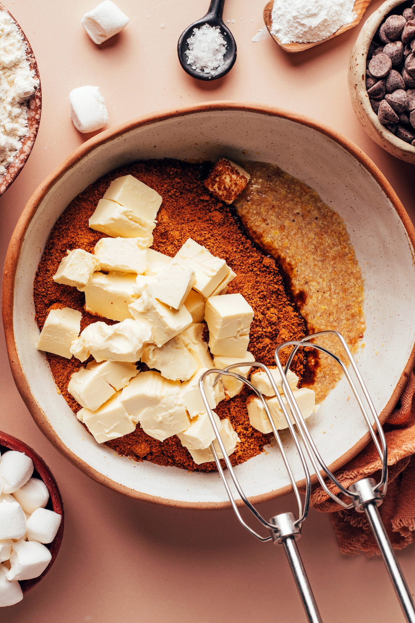 Cubed vegan butter in a bowl with coconut sugar and a flax egg